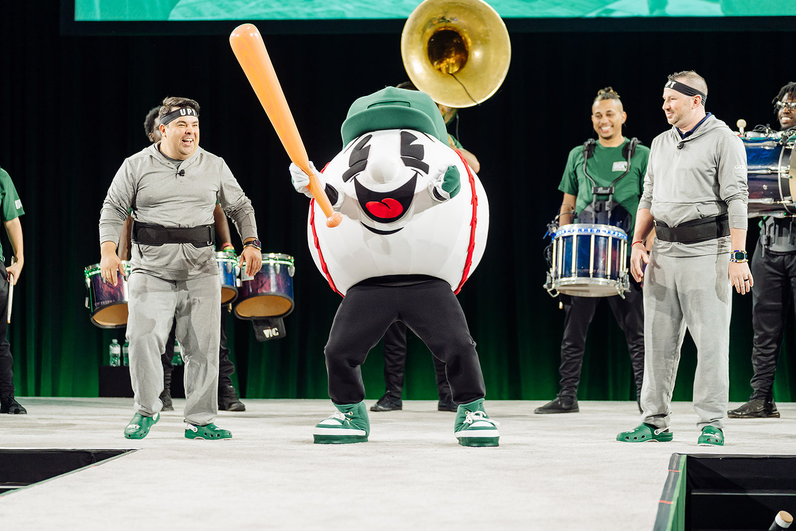 A sports mascot and live drummers perform during a brand experience