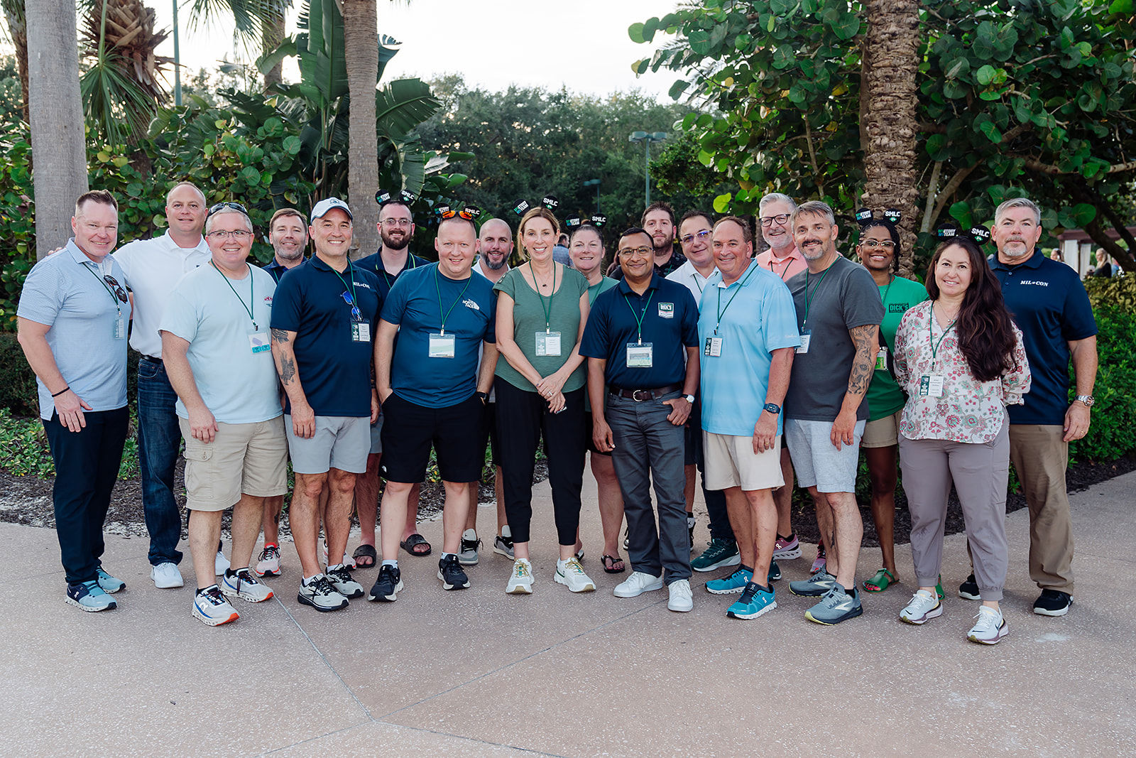 A corporate team gathers outdoors for a relaxed group portrait