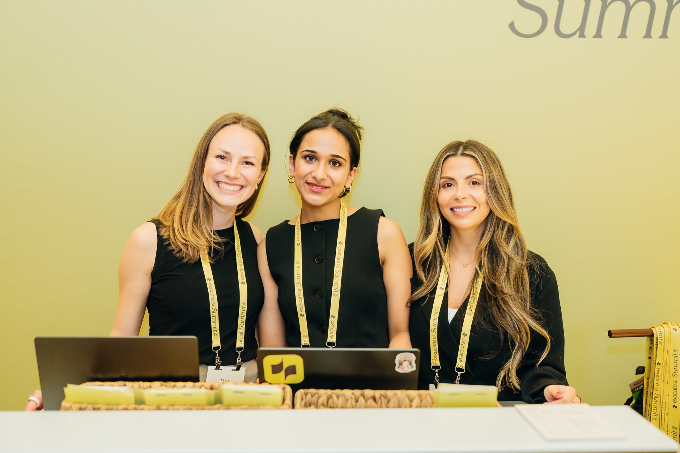 Event professionals welcoming guests at the exacare ai Summit